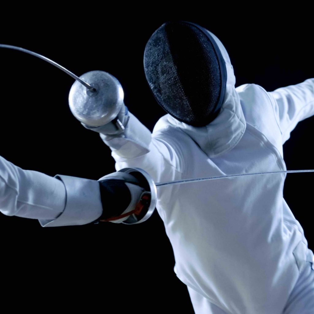 Two Professional Fencers Show Masterful Swordsmanship in their Foil Fight. They Attack, Defend, Leap and Thrust and Lunge. Shot Isolated on Black Background.