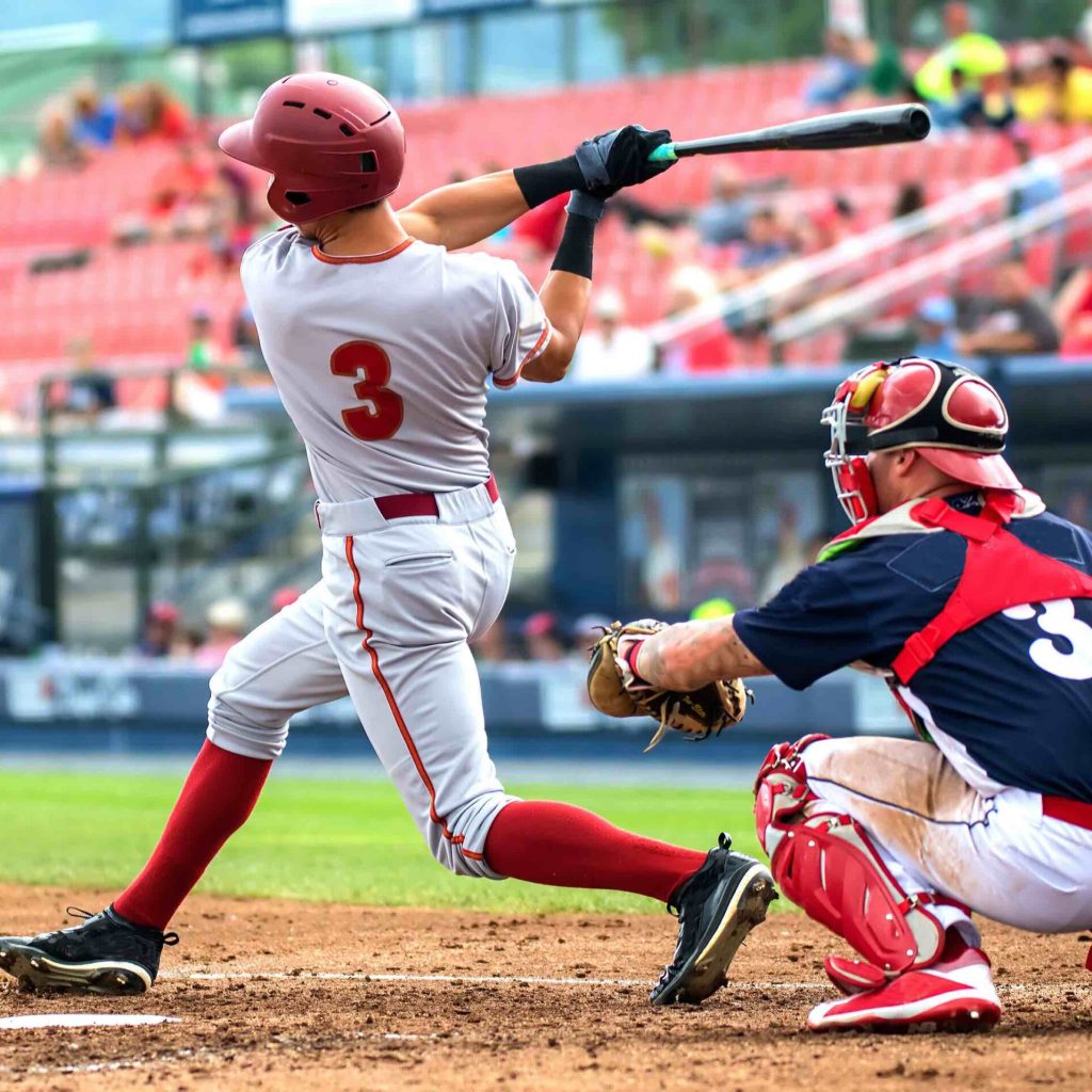 baseball player hitting and sliding