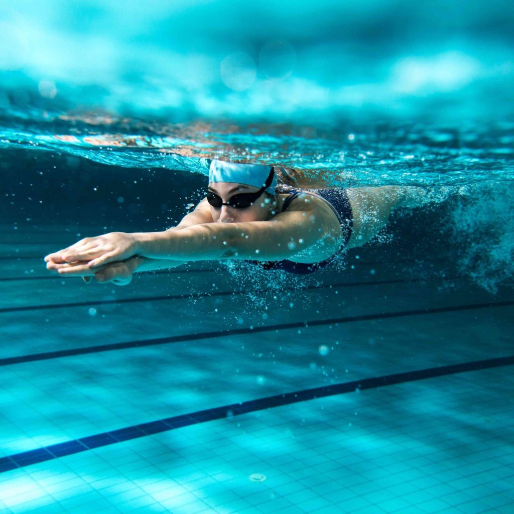 Female swimmer at the swimming pool.Underwater photo.